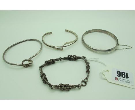 A Hollow Hinged Bangle, engraved detail to the front, hinged to snap clasp, stamped "925"; together with an openwork bangle s