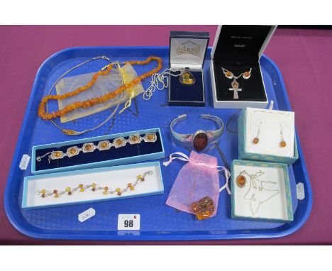 Modern Tumbled Amber Bead Necklace, a square panel bracelet with circular cabochon highlights, an Ankh cross pendant, drop ea