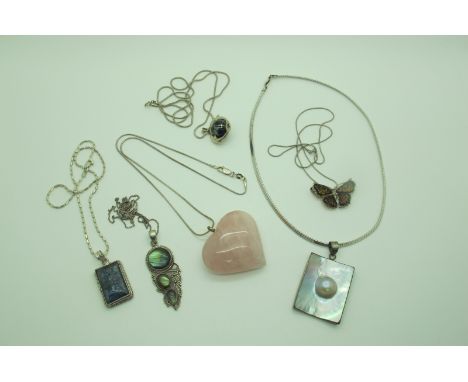 A Large Polished Rose Quartz Heart Shape Pendant, a decorative butterfly pendant stamped "925", rectangular shell panel penda