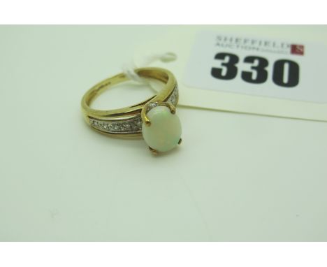 A Modern QVC 9ct Gold Opal Single Stone Ring, oval four claw set, high between inset shoulders (finger size M) (2.5grams). 