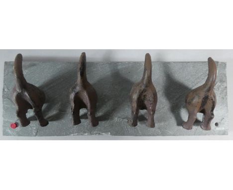 A Novelty Coat Rack in the Form of Four Cast Metal Studies of Terriers down Rabbit Holes Mounted on Slate Bracket, 30cm wide 