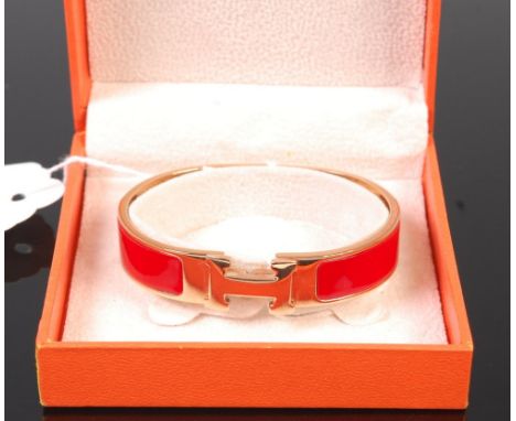 A Hermès of Paris gilt metal and enamel set hinged bangle, in fitted box