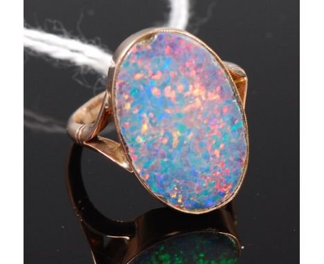 A 9ct gold and large doublet opal set dress ring, size Q, weight 4.8g    Condition Report / Extra Information  Small chip to 