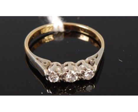 An 18ct gold and platinum diamond three stone ring, total diamond weight estimated 0.18ct, 2.3g, size J