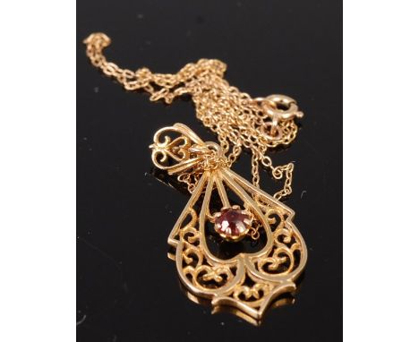 A modern 9ct gold garnet set openwork pendant on finelink neck chain, gross weight 3g