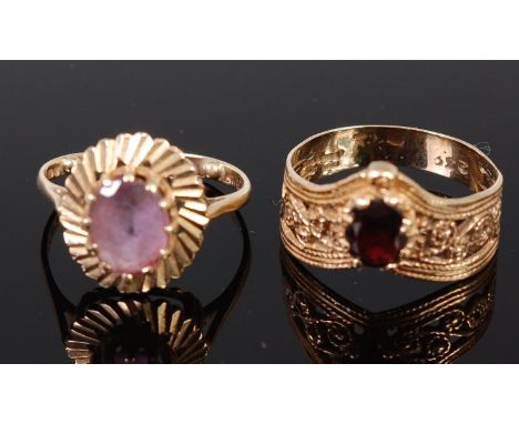 A modern 9ct gold and garnet set dress ring, size W; together with a 9ct gold amethyst ring, gross weight 7.8g (2)