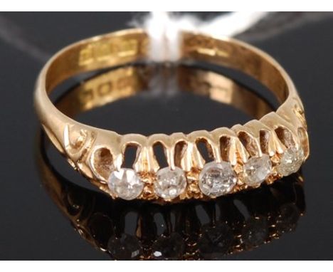 An 18ct gold diamond five stone ring, the claw set old cut graduated diamonds in a line setting, total diamond weight estimat