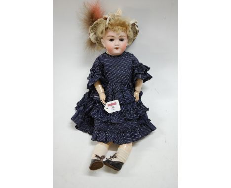 A Max Handwerck German bisque headed doll, having rolling brown eyes and open mouth showing four teeth, with jointed composit