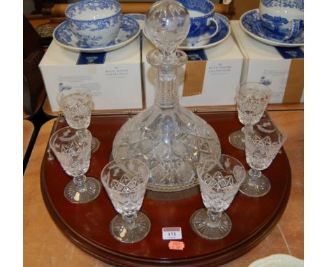 An Edinburgh Crystal ships decanter and stopper together with a matching set of six conical glasses on a mahogany tray