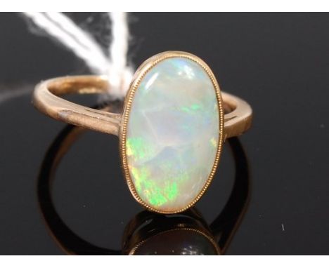 A 14ct gold and cabochon opal set dress ring, 3.1g, opal measures 15x9mm, size P/Q