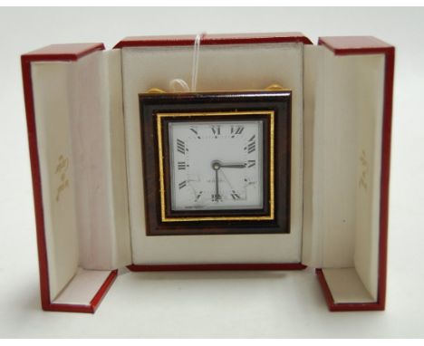 A Must de Cartier travel alarm clock, having square enamelled dial with Roman numerals within walnut surround (glass dial cra