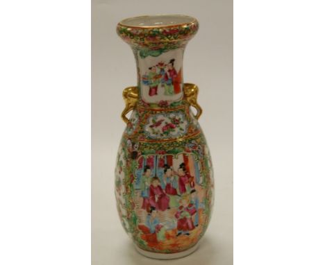 A 19th century Chinese Canton porcelain vase, of slender baluster form, enamel decorated with opposing reserves of ceremonial