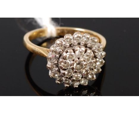 An 18ct gold and diamond set flower head cluster ring, having three rows of old cut diamonds in a tiered setting, total diamo