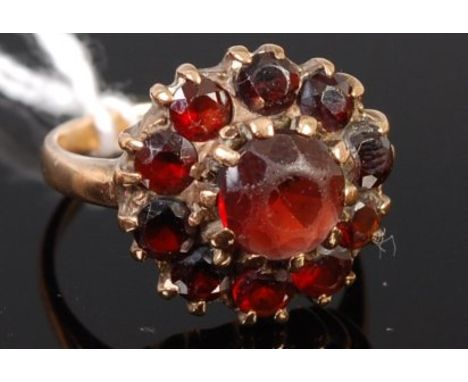 A 9ct gold and garnet set flower head cluster ring, 4.6g, size M