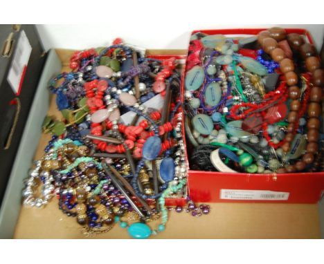 A large collection of assorted costume jewellery to include various beaded necklaces, gold plated fine link chain, etc