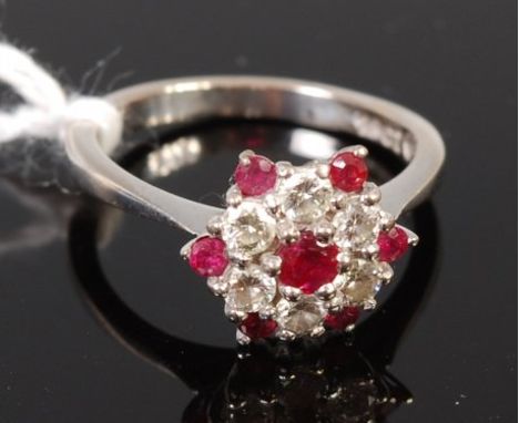 An 18ct white gold ruby and diamond set flower head  cluster ring, size M