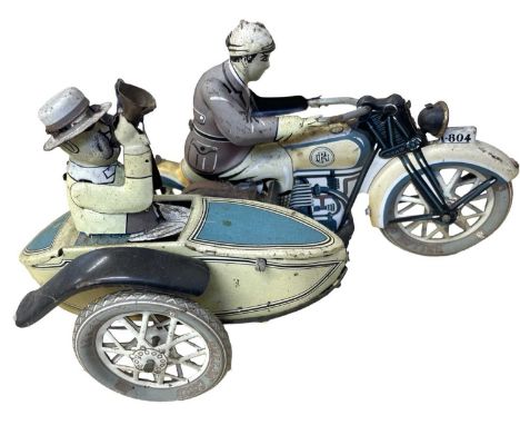 A vintage clockwork tinplate toy, modelled as a motorcyclist with passenger in side-car, possibly by Paya (ES)Faded paintwork