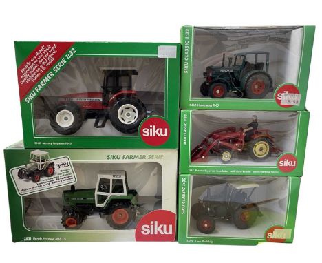 Five boxed Siku 1:32 scale tractor models, to include: - 3460 Hanomag R45 - 2868 Massey Ferguson 9240 - 3467 Porsche with Fro