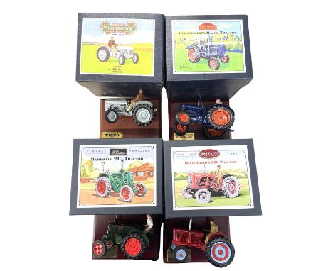 Four boxed Britains die-cast tractor models on wooden plinths, to include: - David Brown 900 - Marshall M - Ferguson TE 20 - 