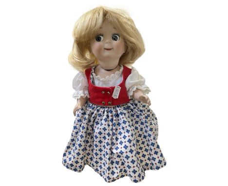 A reproduction German bisque head googly eye-eye doll, in patterned dress with blonde hair and blue eyes.Marked to back of he
