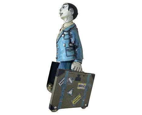 A tinplate clockwork figure, 'El Estudiante'. Some losses to paintwork and light areas of rust, lacking key.Possibly by Paya 