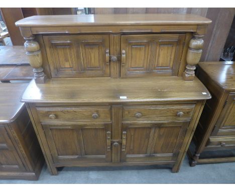An Ercol Golden Dawn court cupboard 