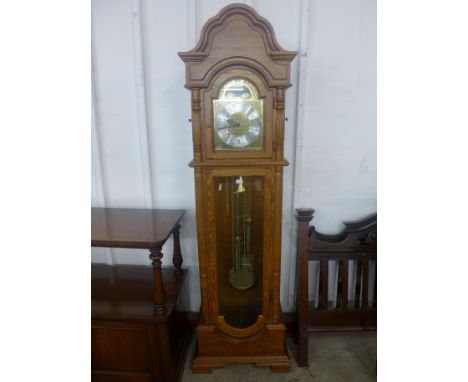 An oak triple weight longcase clock 