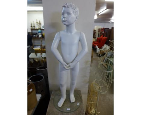 A child's mannequin on a glass base 