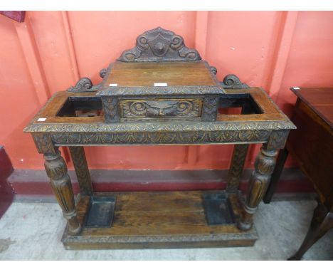 A carved oak stick stand 