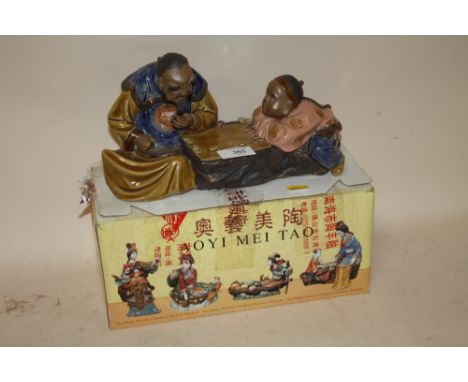 A BOXED AOYIMEITAO ORIENTAL CERAMIC FIGURE OF A MAN AND CHILD PLAYING CHECKERS 