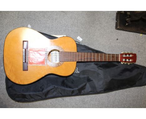 A GEISHA ACOUSTIC GUITAR IN CARRY BAG