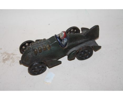 A CAST METAL MODEL OF A MAN IN A RACE CAR LENGTH - 16CM 
