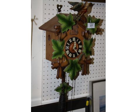 A CARVED WOODEN CUCKOO CLOCK 