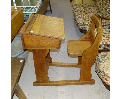 A Vintage oak school desk with attached chair, L86cm 