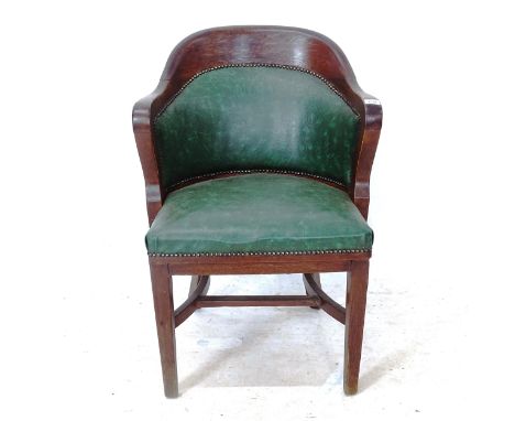 An early 20th century oak Globe-Wernicke desk chair, with studded upholstered seat, and maker's brass label to rear 