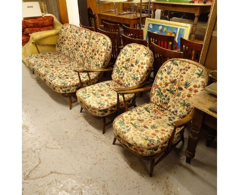 An Ercol stick-back 3-piece suite, comprising a 3-seater settee and a pair of matching armchairs with upholstered loose cushi