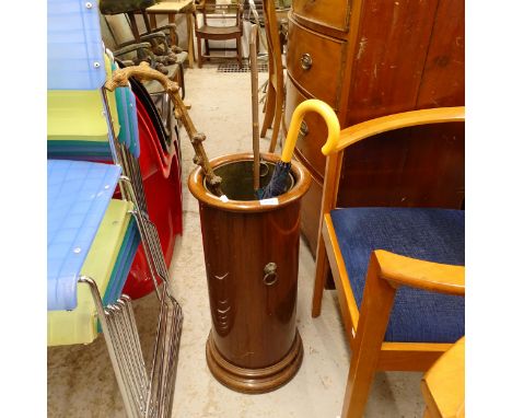 A mahogany cylindrical stick stand, with liner and brass lion mask mounts 