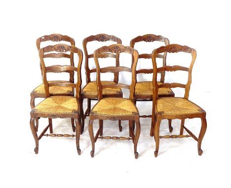 A set of 6 French carved oak ladder-back rush-seated dining chairs 