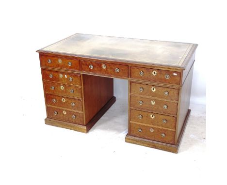 An early 20thC mahogany twin-pedestal writing desk, with a tooled green leather skiver, and fitted drawers, W135cm, H78cm, D7