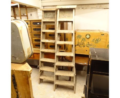 A pair of 8-tread pine step ladders 