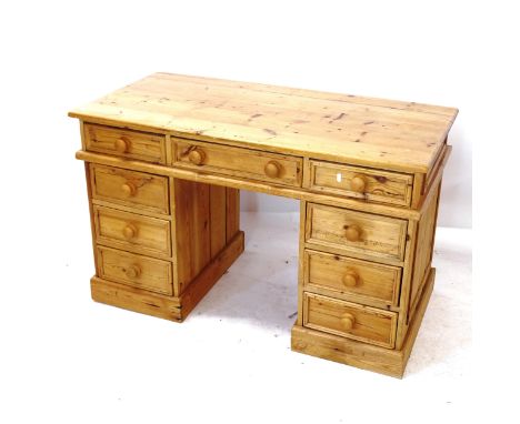 A polished pine pedestal desk with 9 drawers, W121cm, H77cm, D60cm 