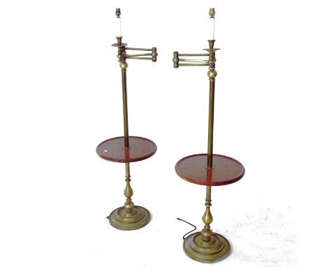 A pair of brass and mahogany library standard lamps, with integral shelf and adjustable arm, height to bayonet fitting 140cmC