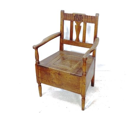 A Victorian Arts and Crafts oak commode chair, with inscription JJH 1870 