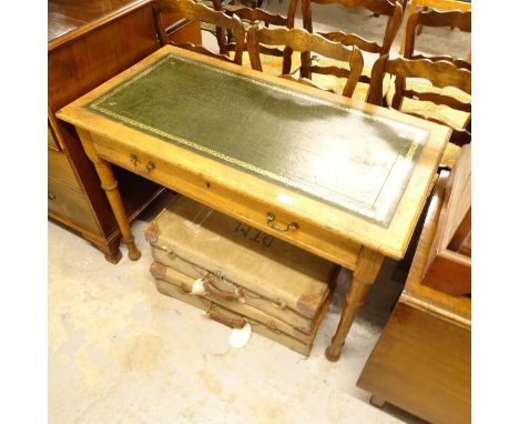 An early 20th century oak writing desk, with a green leather skiver and single drawer, on turned legs, W106cm, H76cm, D55cm 