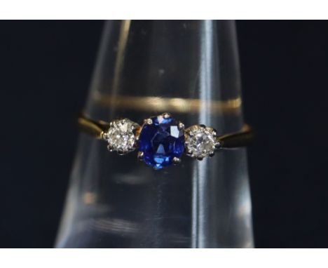 18ct gold three stone diamond and sapphire ring.(B.P. 24% incl. VAT) CONDITION REPORT: Ring size K 1/2.  The sapphire is appr