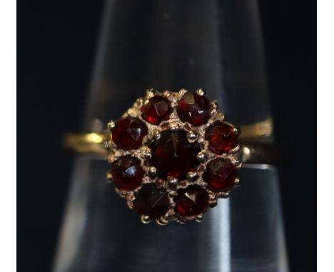 Yellow metal garnet cluster ring. (B.P. 24% incl. VAT)