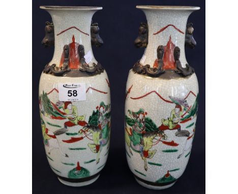 Pair of Chinese crackle glazed porcelain warrior vases, decorated in famille verte pallet on a white ground. Lion dog mask ha