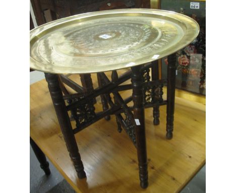 Middle Eastern design, brass top folding table, together with a modern gilt framed fire screen with floral decoration. (2)(B.