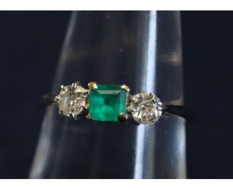 A three stone emerald and diamond ring. (B.P. 24% incl. VAT) 