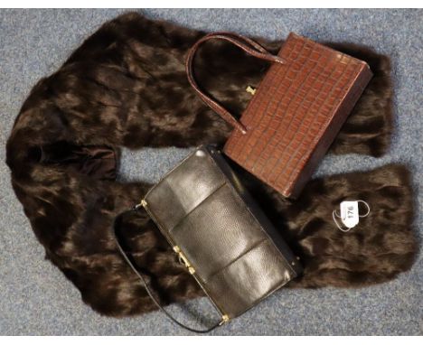 A vintage fur stole together with two vintage handbags, one is a black lizard skin Mappin & Webb handbag and the other a brow